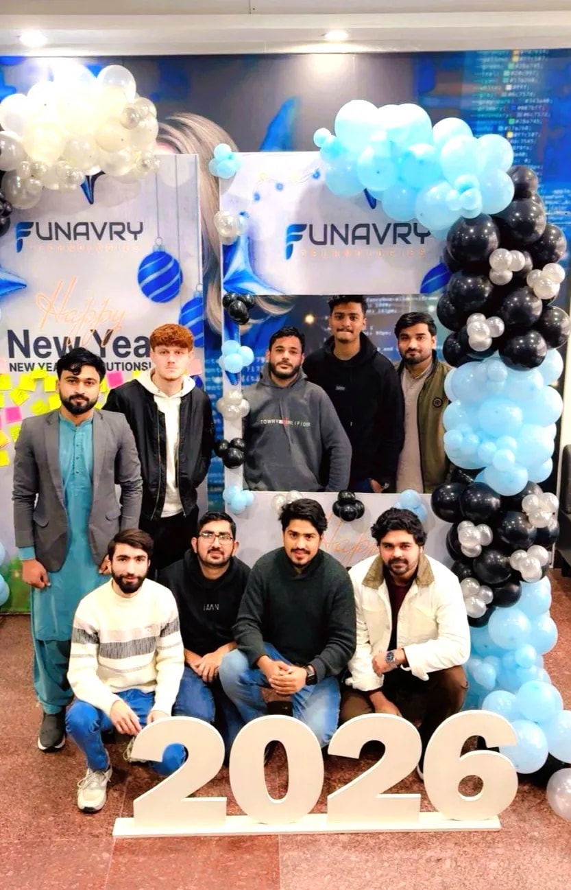 The team gathered around a 2026 sign under blue and white balloons at the office