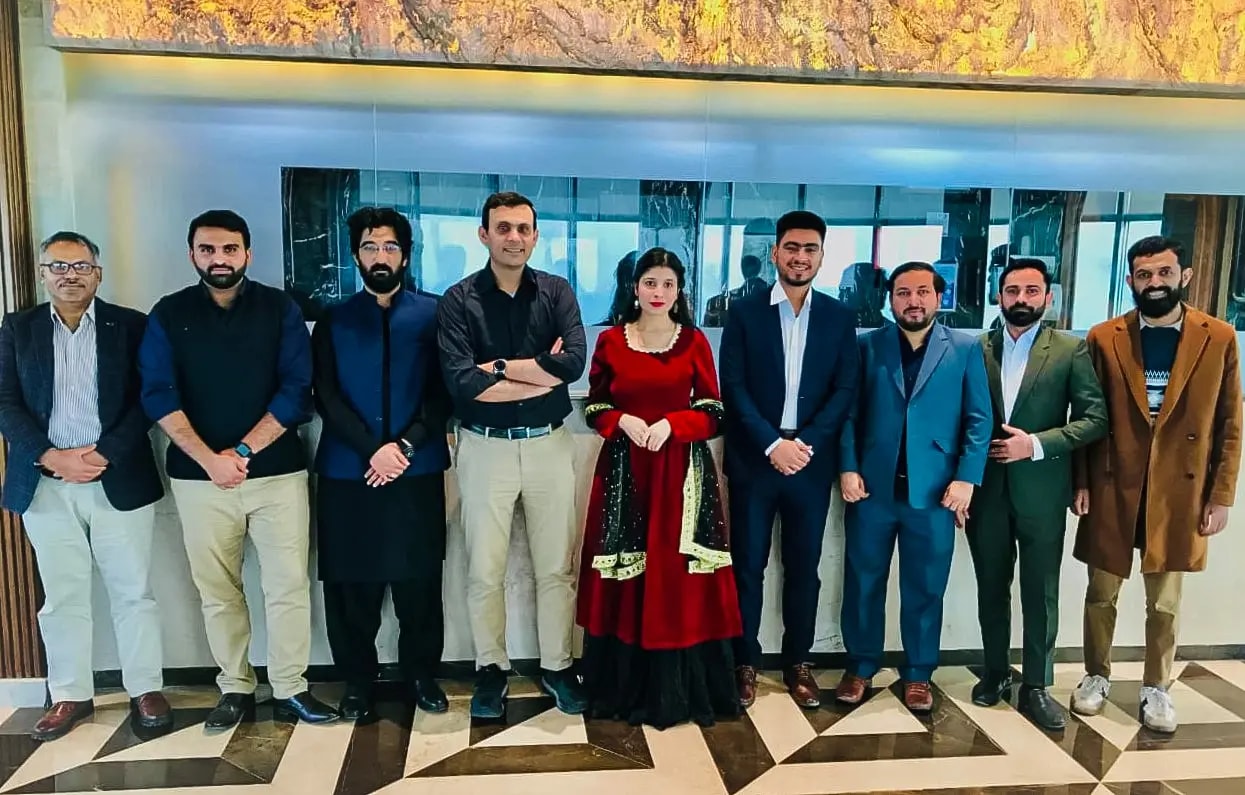 A group of Funavry colleagues dressed formally, standing together in an office lobby