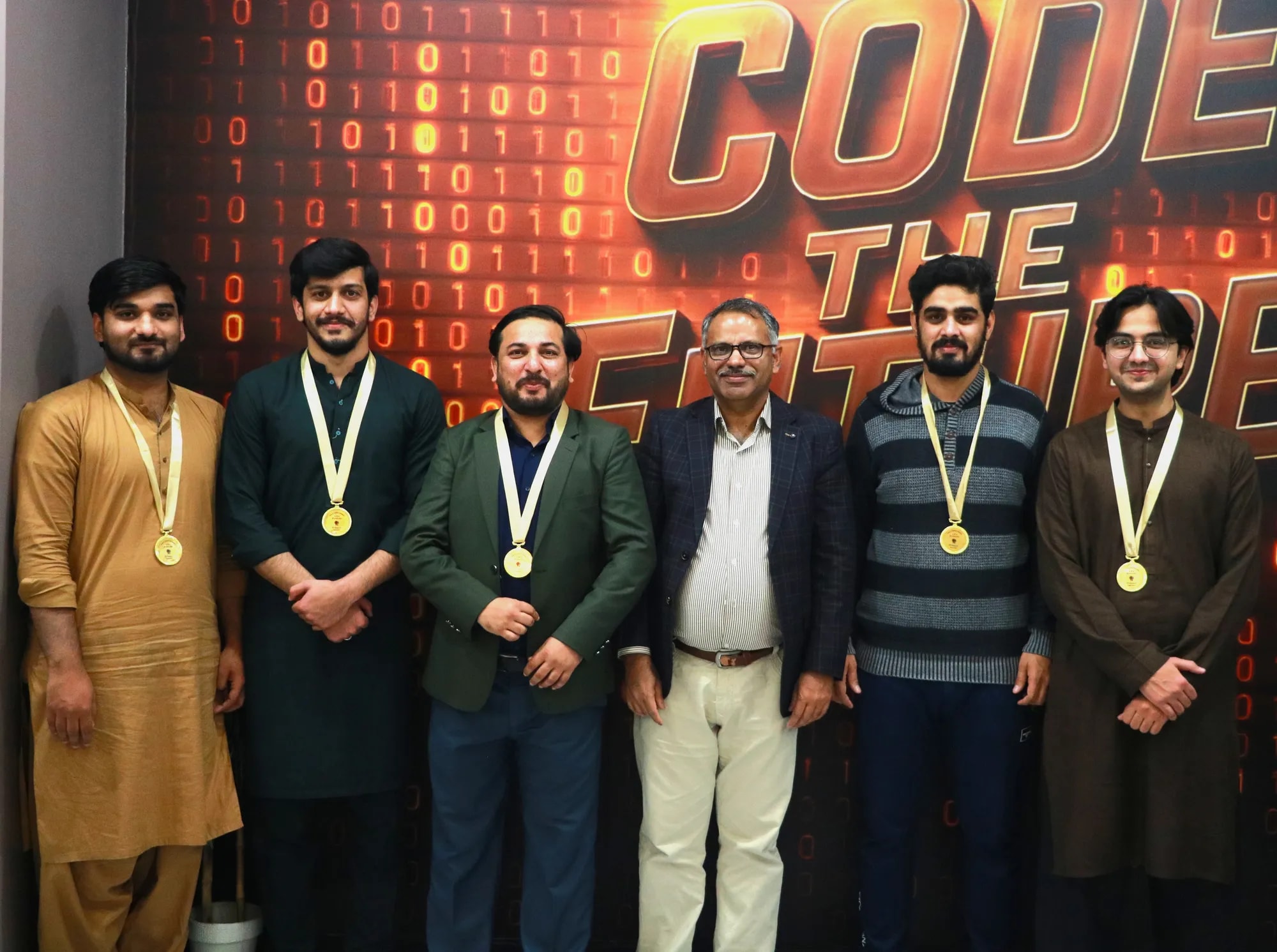 The table-tennis winners in a row wearing their medals