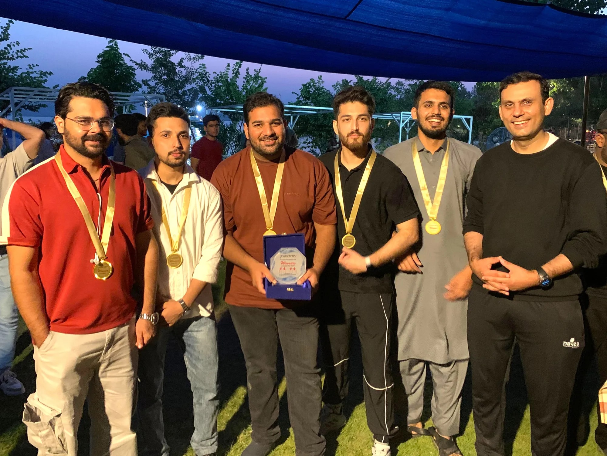Medal winners lined up together outdoors